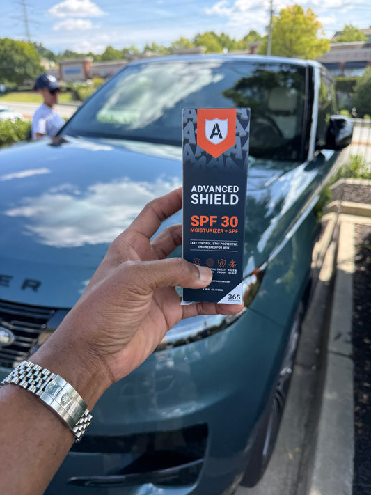 Customer holding the APEX Advanced Shield SPF 30 box outdoors in a parking lot in direct sun